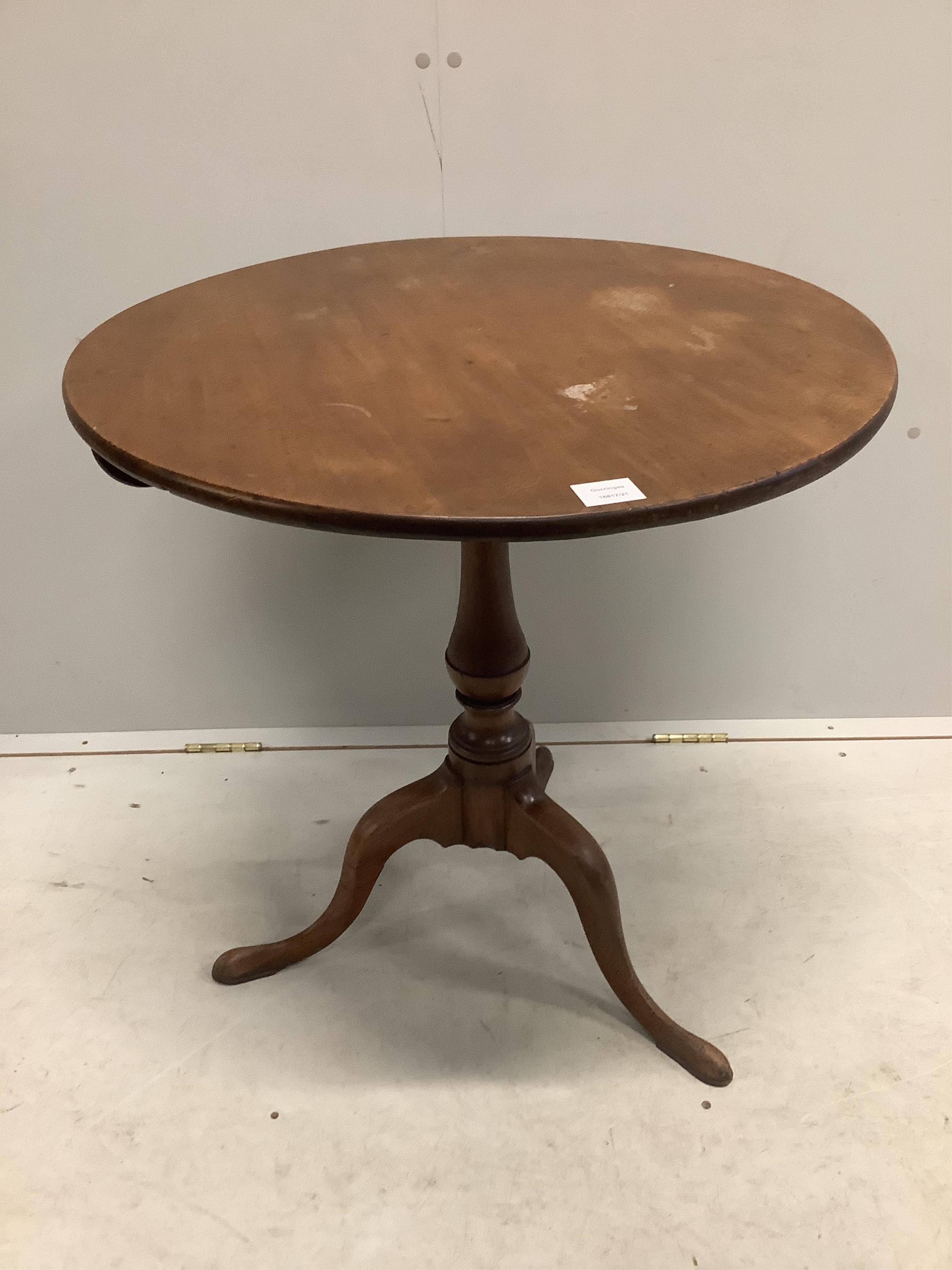 A George III circular mahogany tilt top tripod tea table, diameter 69cm, height 72cm. Condition - fair